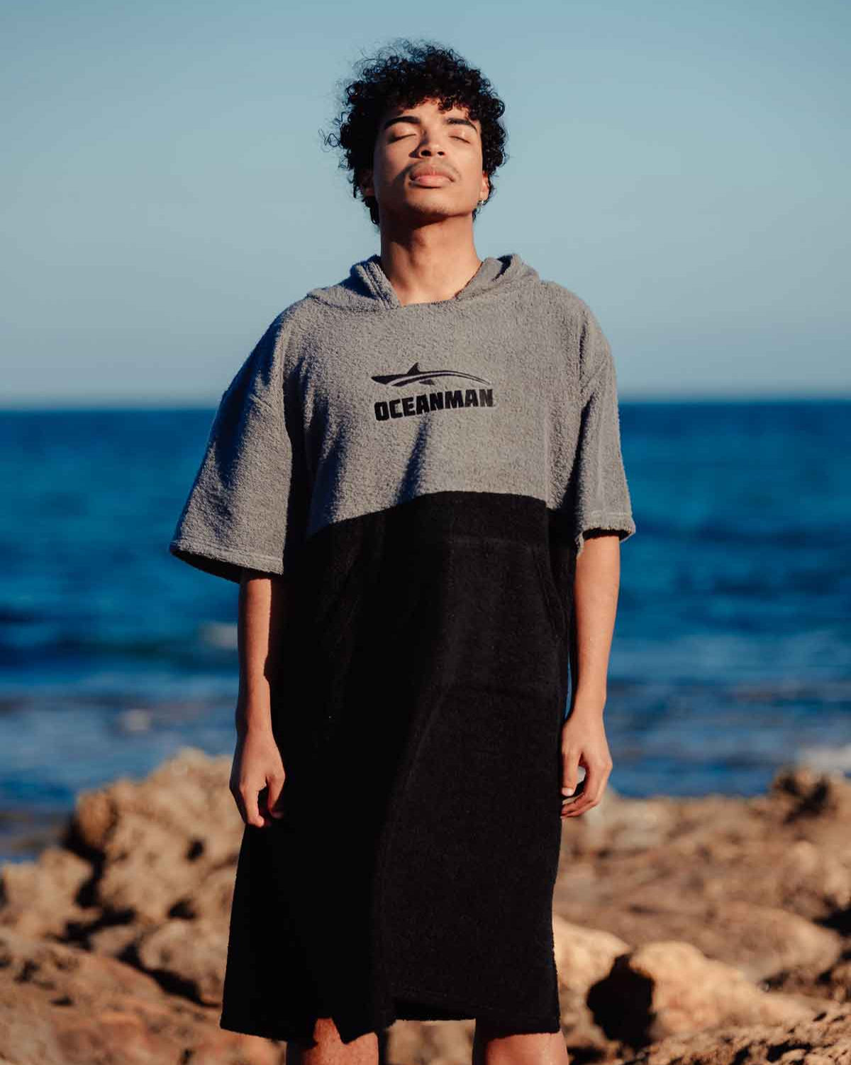 Man wearing oceanman poncho at the beach